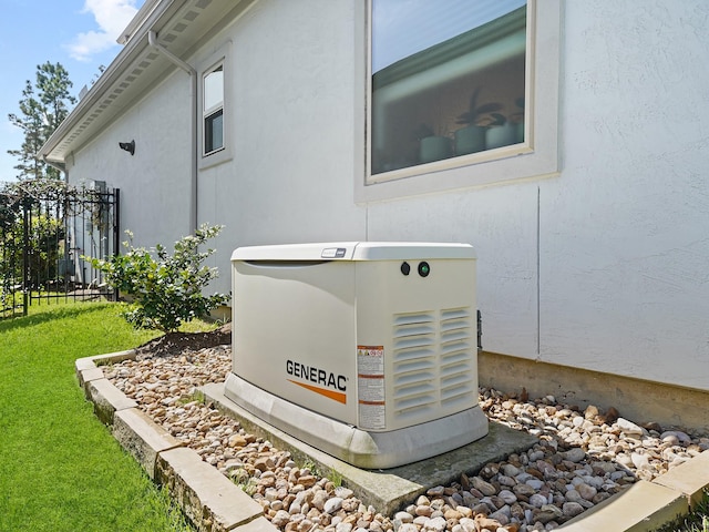 details with stucco siding, a power unit, and fence