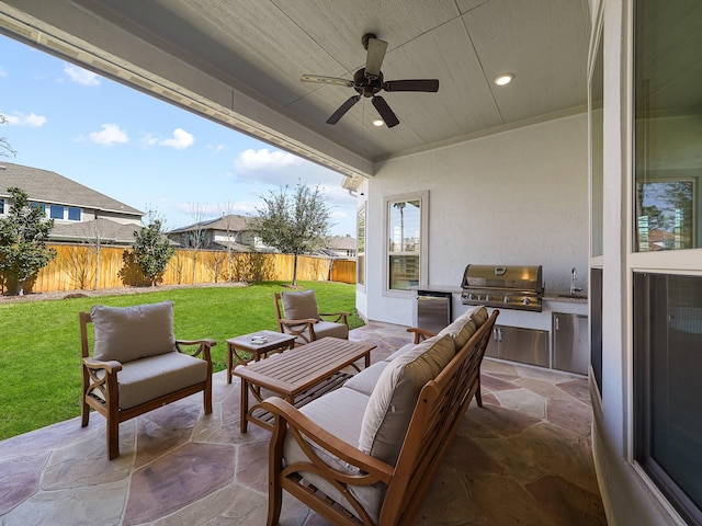 view of patio / terrace with area for grilling, outdoor lounge area, exterior kitchen, and a fenced backyard