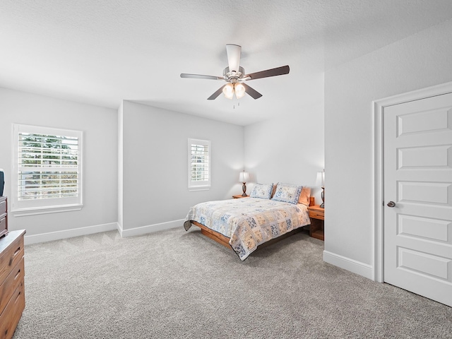 bedroom featuring baseboards, light carpet, and ceiling fan