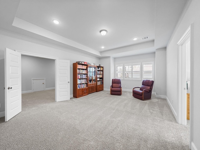 sitting room featuring visible vents, baseboards, carpet flooring, recessed lighting, and a raised ceiling