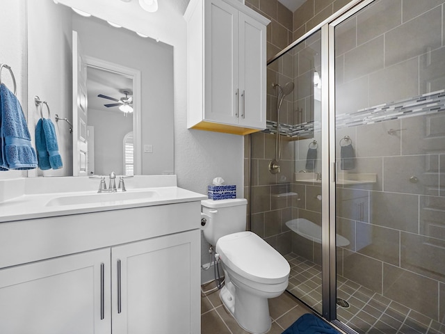 full bath with vanity, ceiling fan, a shower stall, and toilet