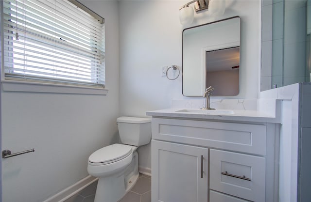 bathroom with baseboards, vanity, toilet, and tile patterned floors