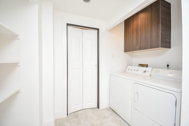 laundry room with cabinet space and washing machine and clothes dryer