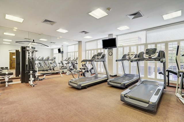 workout area featuring visible vents and carpet flooring