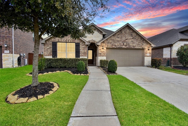 view of front facade with a garage, driveway, a front lawn, and brick siding