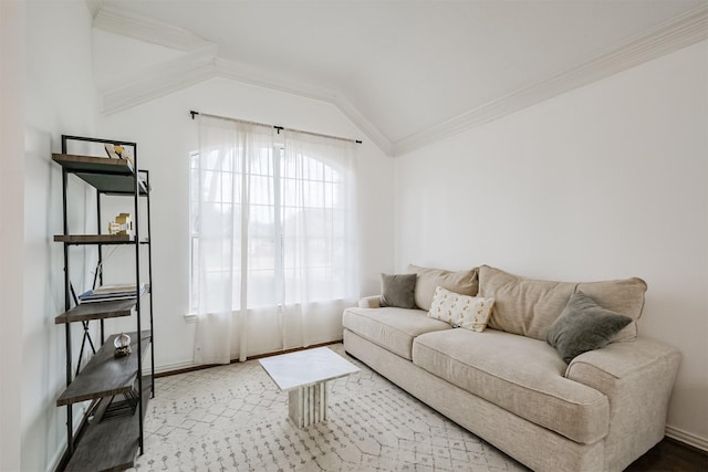 living room with vaulted ceiling, ornamental molding, and baseboards