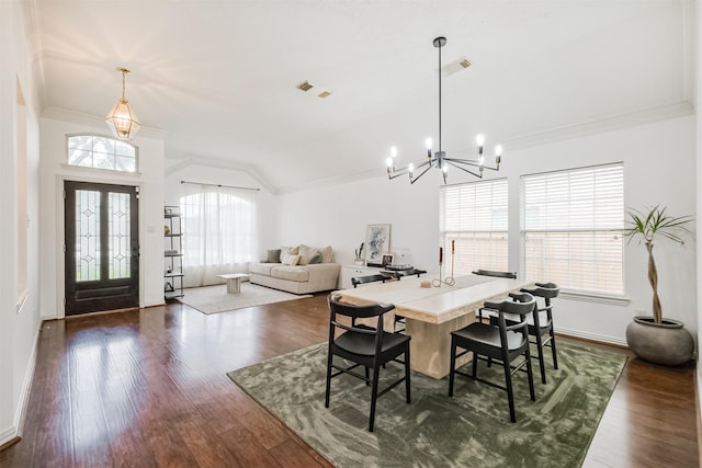 dining area featuring crown molding, dark wood finished floors, lofted ceiling, visible vents, and an inviting chandelier