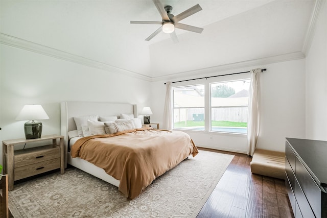 bedroom featuring lofted ceiling, wood-type flooring, crown molding, and ceiling fan