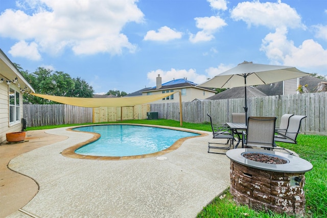 view of swimming pool featuring a patio, a fenced backyard, a fire pit, a fenced in pool, and outdoor dining space