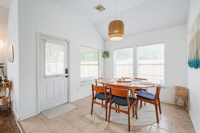 dining room featuring vaulted ceiling, light tile patterned floors, visible vents, and baseboards