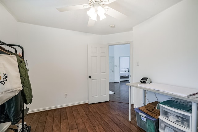 office space featuring ceiling fan, baseboards, and dark wood-type flooring