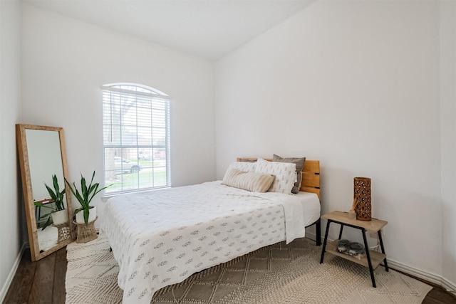 bedroom with wood finished floors and baseboards