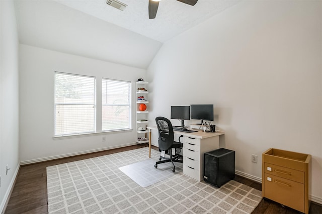 office with ceiling fan, wood finished floors, visible vents, baseboards, and vaulted ceiling