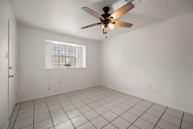 spare room featuring ceiling fan, visible vents, and a textured ceiling