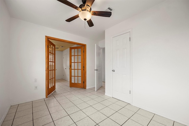 spare room featuring french doors, visible vents, ceiling fan, and light tile patterned floors