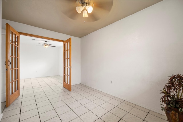 empty room with french doors, ceiling fan, and light tile patterned floors