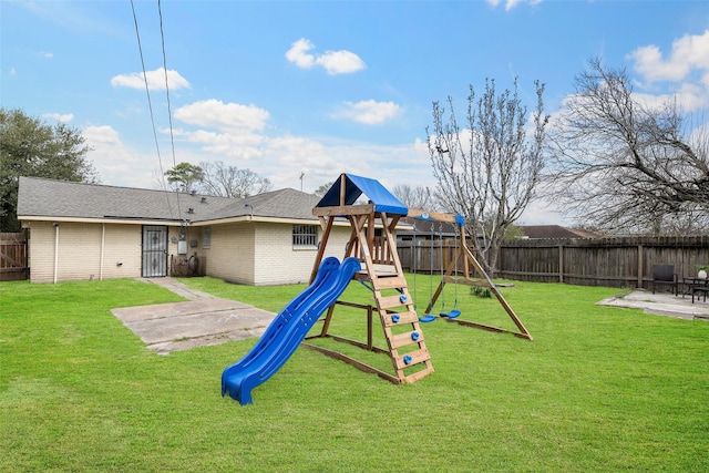 view of jungle gym with a fenced backyard, a patio, and a yard