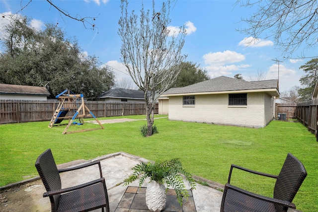 view of yard with a fenced backyard, cooling unit, a playground, and a patio