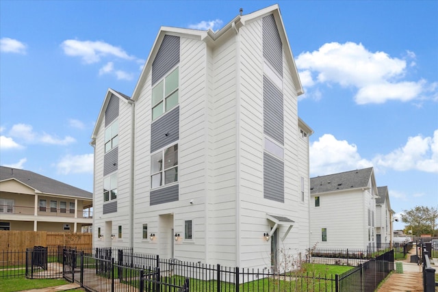 view of side of home featuring fence