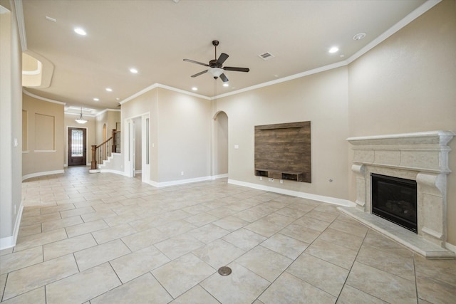 unfurnished living room with a ceiling fan, a high end fireplace, light tile patterned flooring, and baseboards