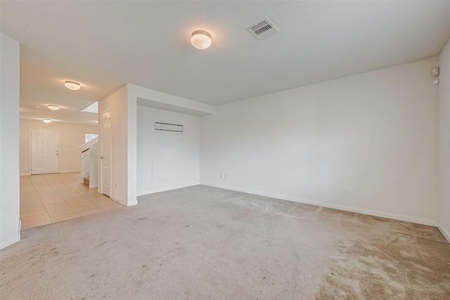 tiled empty room featuring stairs, carpet, visible vents, and baseboards