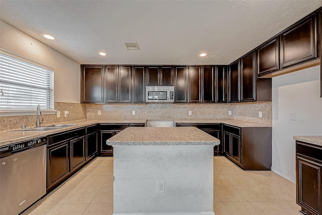 kitchen with stainless steel appliances, visible vents, a sink, and light tile patterned floors