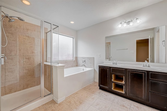 bathroom featuring a garden tub, tile patterned flooring, a sink, and a shower stall