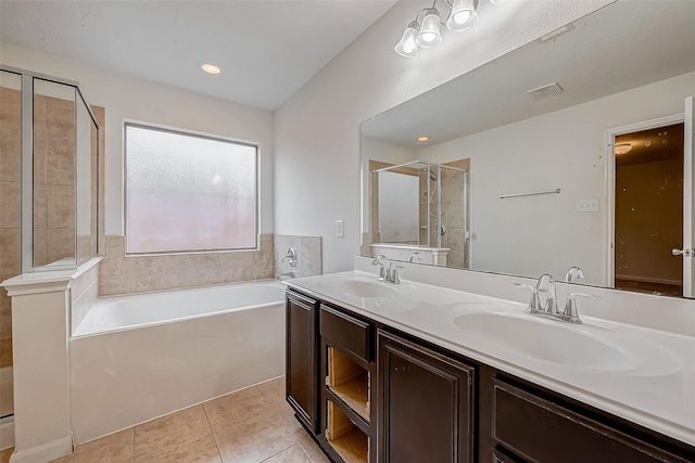 bathroom featuring tile patterned flooring, a shower stall, visible vents, and a sink