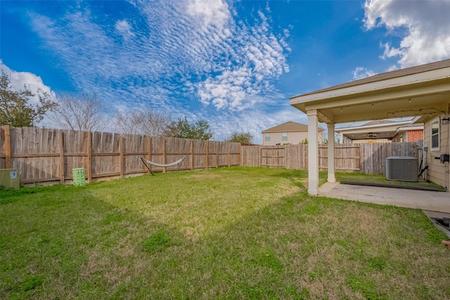 view of yard with a fenced backyard, a patio, and central AC