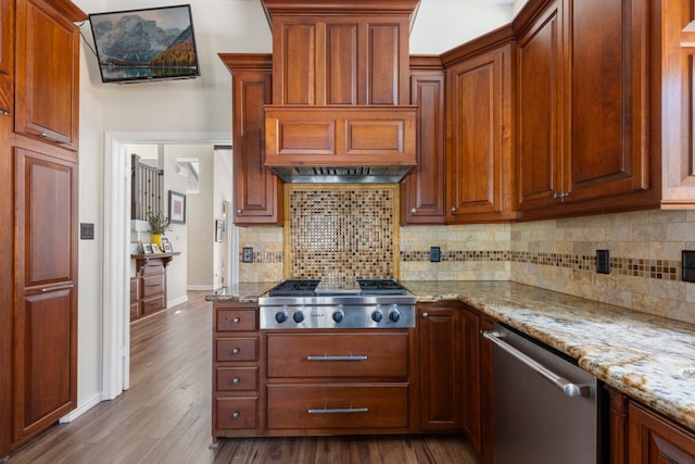 kitchen with stainless steel appliances, dark wood-type flooring, decorative backsplash, and light stone countertops