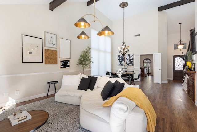 living area with a notable chandelier, beam ceiling, high vaulted ceiling, and dark wood-type flooring