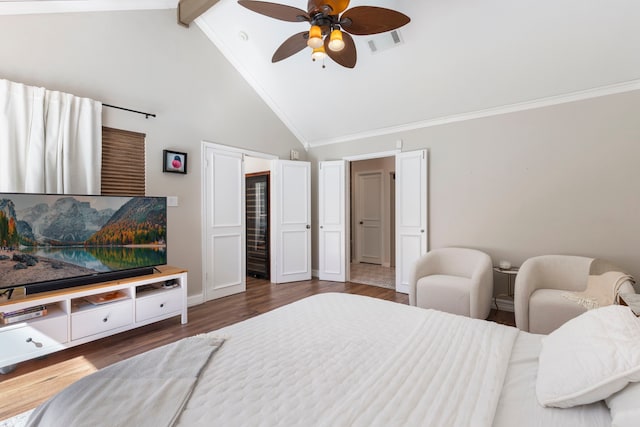 bedroom featuring crown molding, visible vents, and wood finished floors