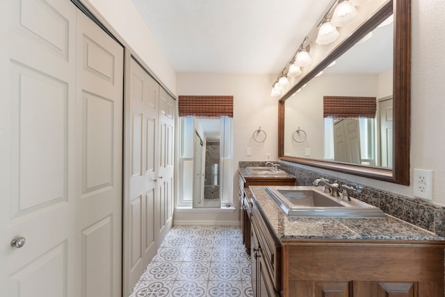 full bath with tile patterned flooring, a healthy amount of sunlight, a shower with door, and vanity