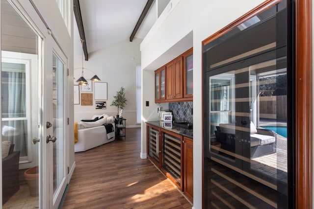 kitchen with beverage cooler, brown cabinets, dark countertops, dark wood finished floors, and glass insert cabinets