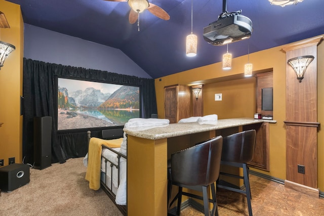 cinema room featuring vaulted ceiling and ceiling fan