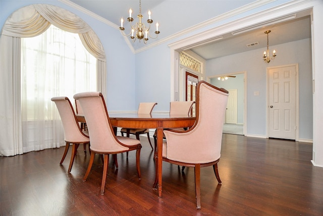 dining room featuring visible vents, crown molding, baseboards, wood finished floors, and a notable chandelier