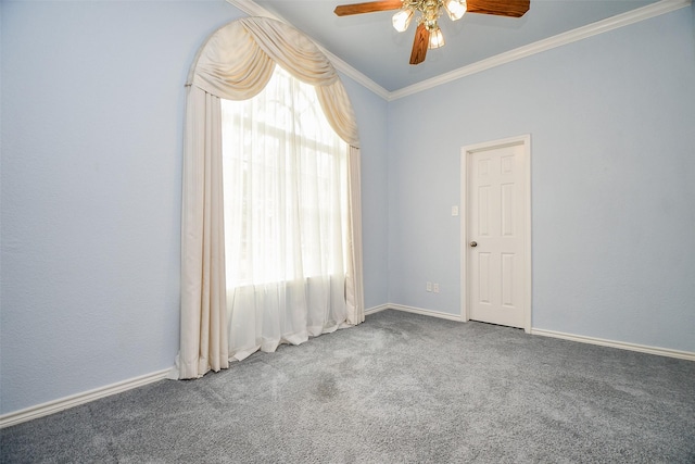 carpeted empty room with ceiling fan, baseboards, and ornamental molding