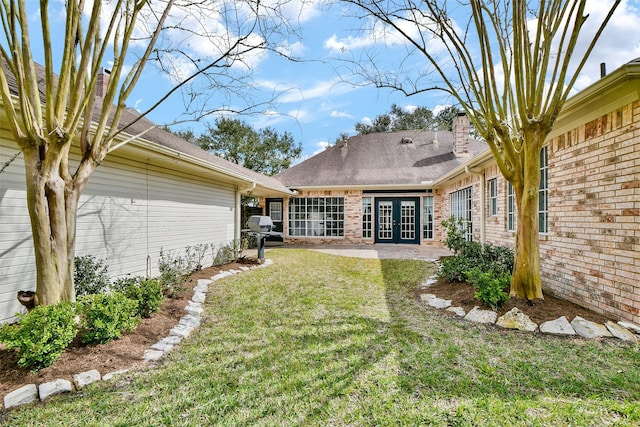 view of yard featuring a patio area and french doors