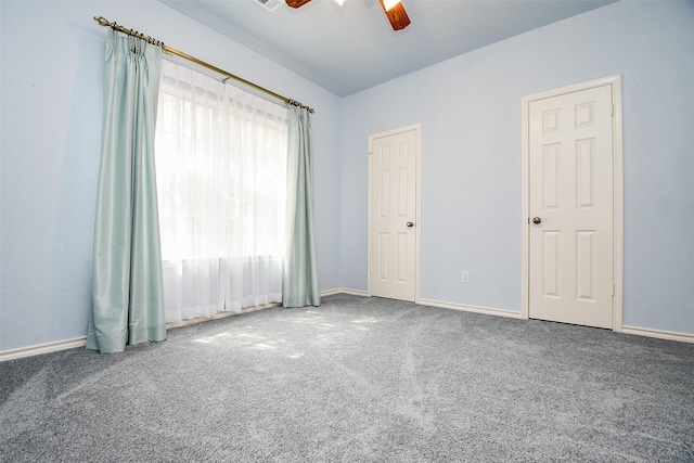 empty room with baseboards, a ceiling fan, and carpet