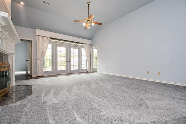 unfurnished living room featuring visible vents, high vaulted ceiling, french doors, carpet, and a fireplace