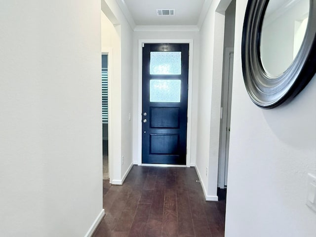 doorway to outside with baseboards, crown molding, visible vents, and dark wood-style flooring