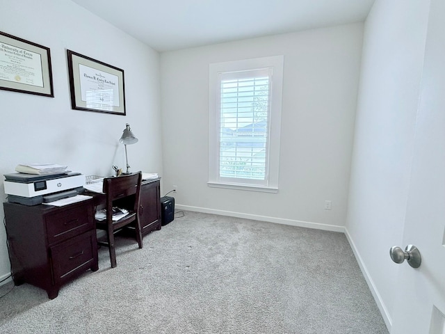 office featuring light carpet and baseboards