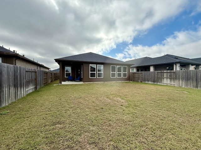 back of property featuring a lawn, a patio area, and a fenced backyard