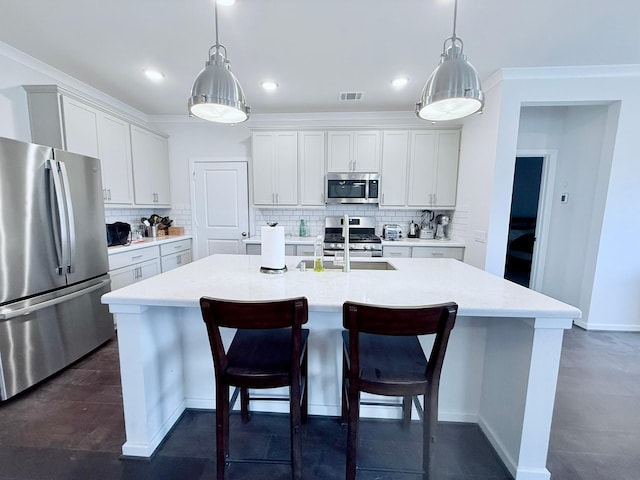 kitchen with a breakfast bar, a center island with sink, stainless steel appliances, visible vents, and decorative backsplash