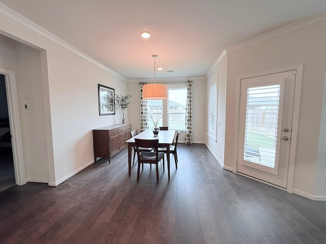 dining area featuring ornamental molding, dark wood-type flooring, and baseboards