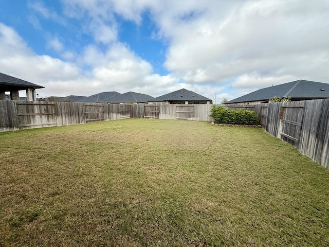 view of yard with a fenced backyard