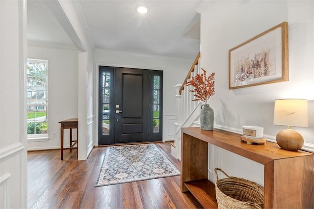 entryway with stairway, wood finished floors, and ornamental molding