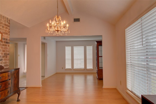 dining room featuring visible vents, a notable chandelier, lofted ceiling with beams, and light wood finished floors