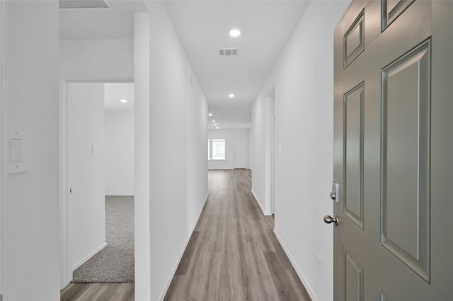 corridor with recessed lighting, wood finished floors, visible vents, and baseboards