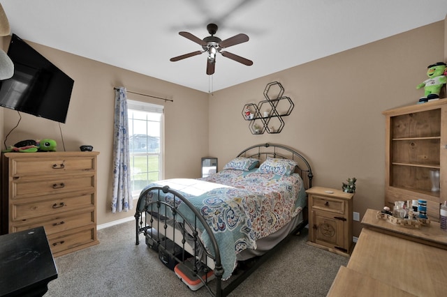 bedroom featuring baseboards, a ceiling fan, and carpet flooring